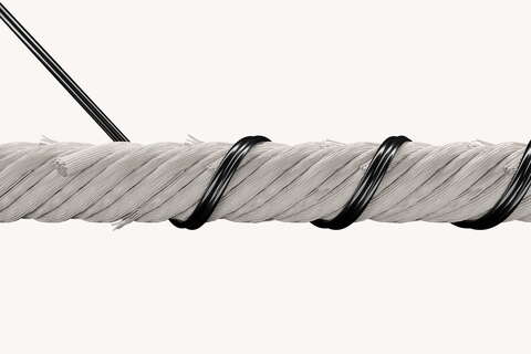 A thick, white rope is tightly coiled with black wire against a plain background, showcasing detailed texture.