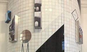 A geometric art installation combines tiles and 3D elements on a curved wall, featuring abstract shapes and architectural photos.