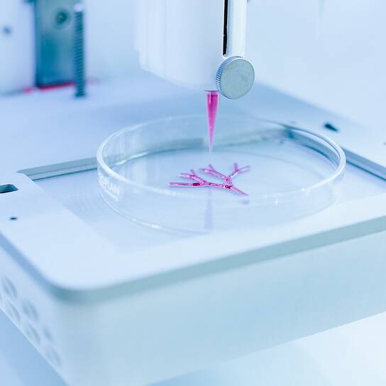 R3 - BUSINESS AREAS - Celllink A 3D bioprinter deposits pink biomaterial into a petri dish, demonstrating CELLINK's innovative bioprinting technology.