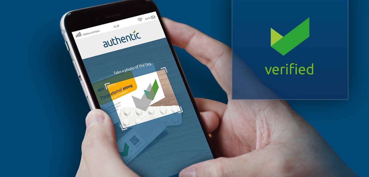 A person uses a smartphone app to verify a medication's authenticity, showing a green checkmark indicating "verified" status.